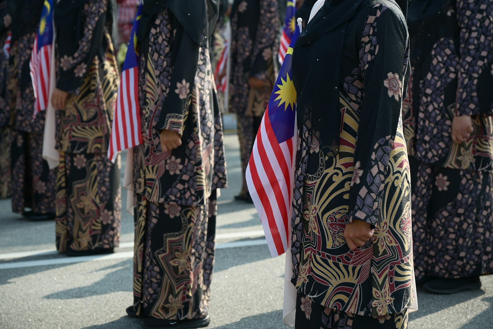 People holding Malaysian flags at a public event in George Town, Penang